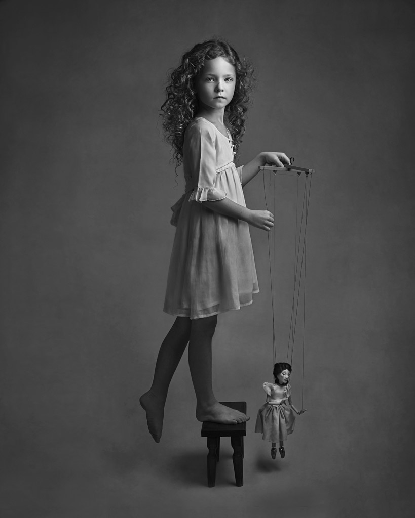 Delilah and the Puppet, © Lisa Visser, UK, Honorable Mention in the Portrait Category, 2nd Half, B&W Child Photo Contest